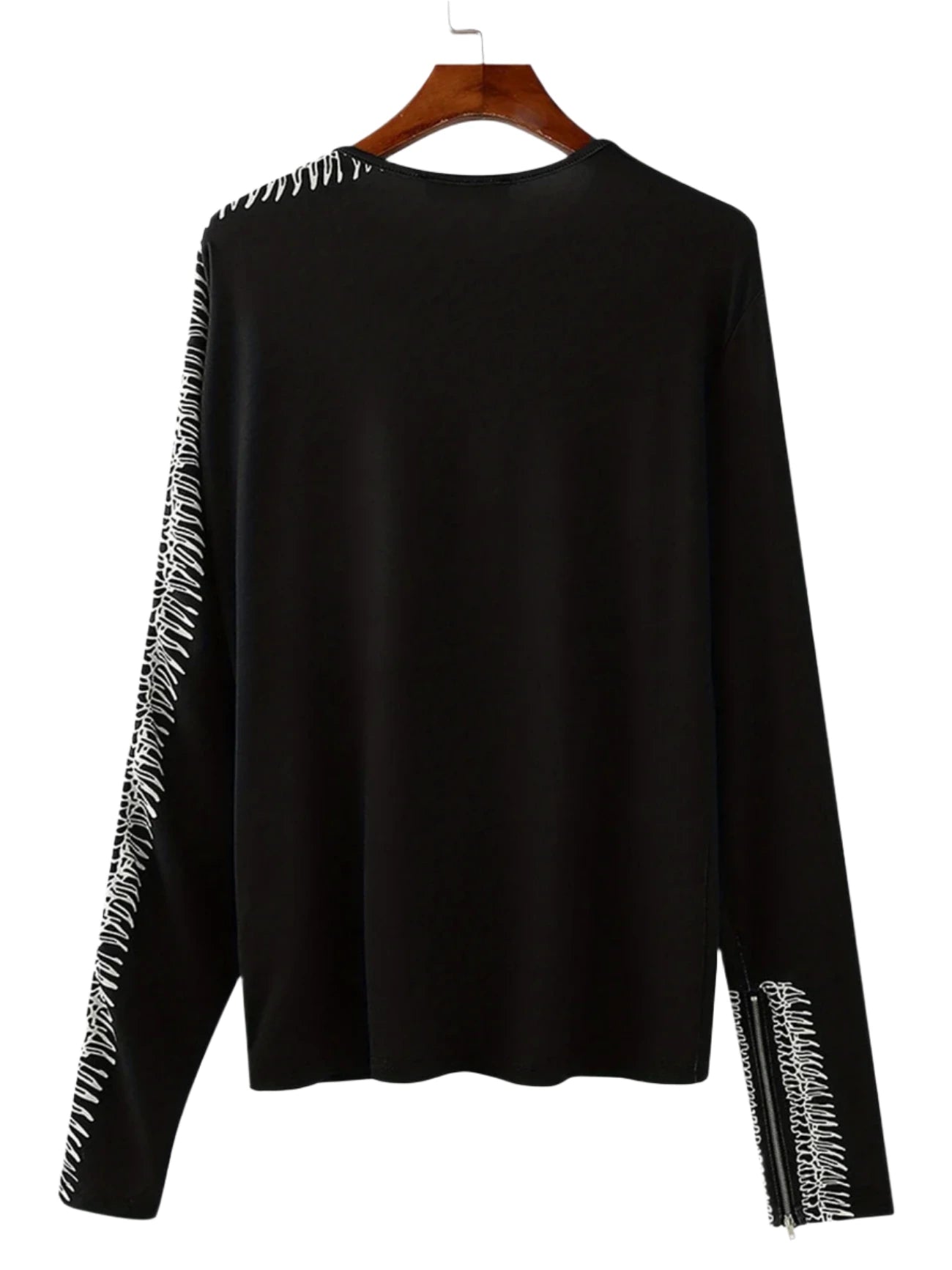 Black long-sleeve top with white fringe details on a gray background