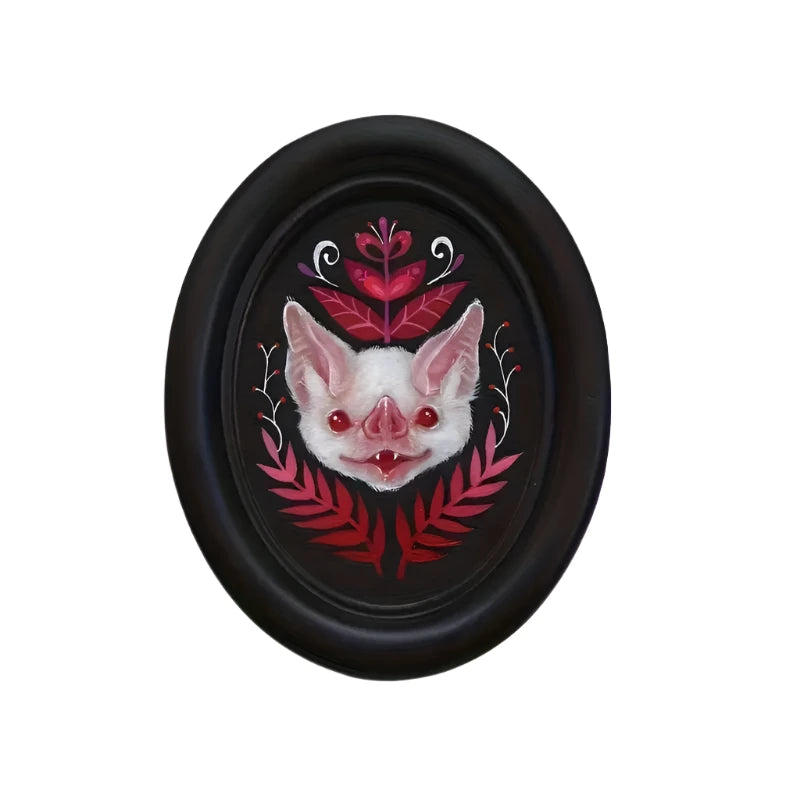 Black The Dark Arts: Cotton Candy Bat with White bat with pink leaf motif in a black oval frame. Measures in a gothic alternative.